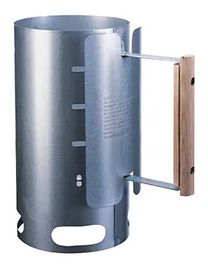 Lodge Chimney Charcoal Starter with wooden handle on a grill