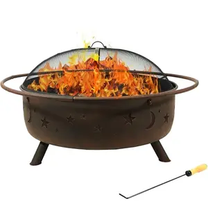 Large round bronze fire pit with star and moon cutouts, spark screen, and poker on a patio