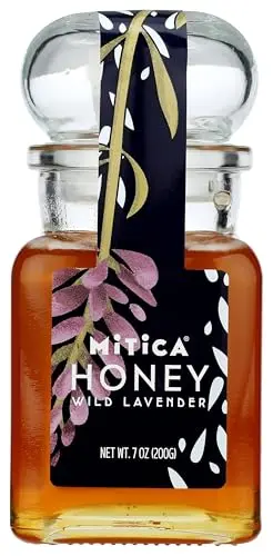 Mitica Lavender Honey in apothecary-style glass bottle next to cheese and scones