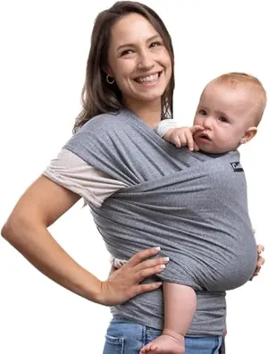 Parent wearing the Cuddlebug baby wrap carrier with a newborn snuggled inside