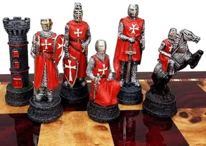 Red and blue Maltese knight chess pieces set on a wooden board, no board included