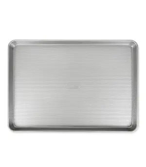 USA Pan extra large nonstick cookie sheet on a kitchen counter