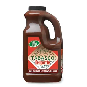 Half-gallon jug of TABASCO Chipotle Pepper Sauce with grilled meats and smokey background