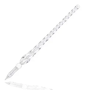 Molshine glass dip pen with spiral design on a wooden desk