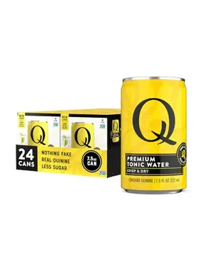 Q TONIC WATER cans on a table with citrus garnish