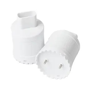 Two white Flood Buzz Pro water leak detectors on a wooden floor next to a puddle