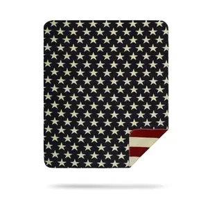Denali stars and stripes plush blanket in reversible fleece on a bed