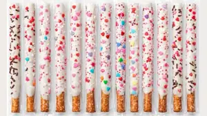 Individually wrapped white chocolate dipped pretzel rods for Valentine's Day