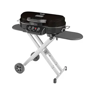 Coleman RoadTrip 285 portable propane grill standing with wheels and three burners