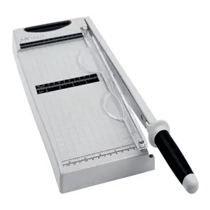 Tim Holtz Maxi guillotine paper cutter extended to 12 inches on a worktable