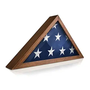 Rustic brown triangular flag display case with glass front, displaying a folded 5x9.5 burial flag on a wooden table.