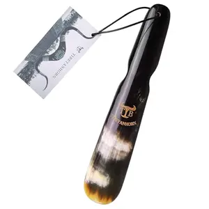 Tibetanhorn yak horn shoe horn with natural pattern on wooden surface