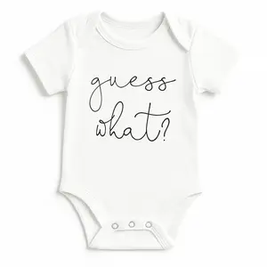 White baby onesie with Guess What? text for pregnancy announcement