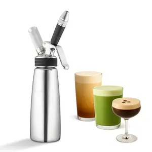 Stainless steel NitroPress infuser pouring a cascading nitro cold brew into a glass