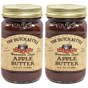 Two 18-ounce mason jars of Amish Homemade Style Apple Butter from The Dutch Kettle, tied with a red ribbon.
