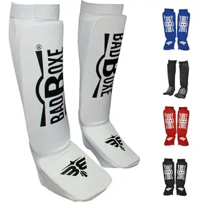 BadBoxe Elastic Cloth Shin Guards in white and black, small/medium size