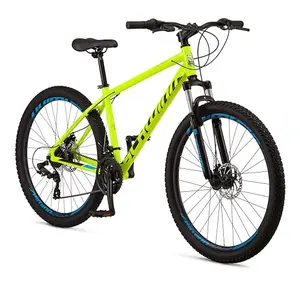 Schwinn yellow aluminum mountain bike leaning against a tree