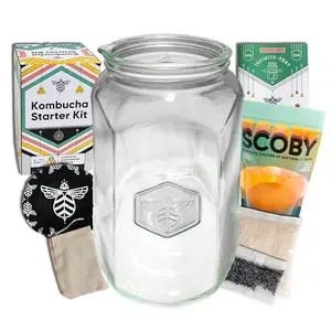 Craft A Brew kombucha starter kit with custom glass jar, SCOBY, tea, and sugar on a kitchen counter