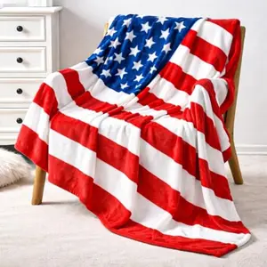 American flag fleece blanket draped over a sofa with patriotic pillow
