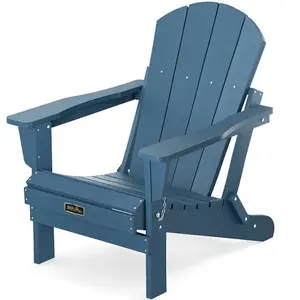 Blue folding Adirondack chair on a grassy lawn by the lake