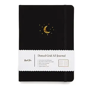 Yop & Tom Moon and Stars bullet journal with charcoal cover lying open on a desk