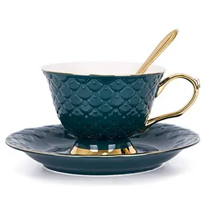 Single green teacup with embossed fish scale pattern and gold rim, on a saucer