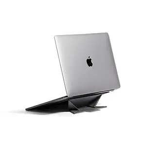 Native Union Rise black ultra-slim foldable stand attached to bottom of a laptop, lifted with small angle