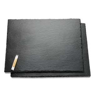 Two large rectangular black slate cheese boards with chalk on white background