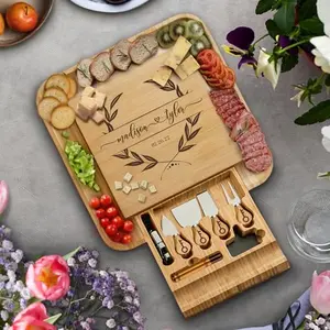 Bambusi personalized charcuterie board with hidden knife drawer and slate labels on a wooden table