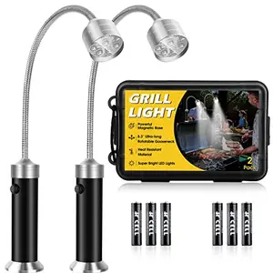 Two Apicey grill lights attached to a grill with flexible goosenecks extended
