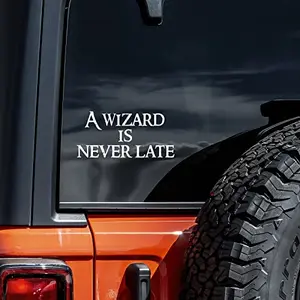 White vinyl decal with the quote 'A Wizard is Never Late' on a transparent background, 5.5x2.5 inches
