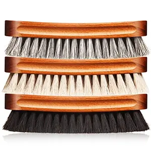 Three large horsehair shine brushes in a metal box