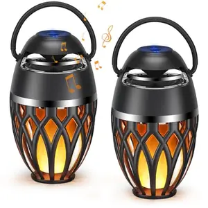 Two MOFOKEAY outdoor Bluetooth speakers with LED flame flickers on a patio table