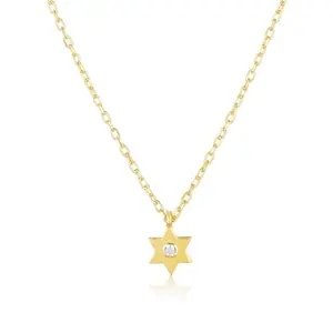 Tiny gold Star of David pendant with one cubic zirconia stone next to it