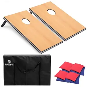 Outball cornhole set with flag design on a lawn, including boards, bean bags, and carrying case