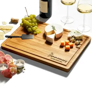 Custom engraved bamboo cutting board with family name and established date on kitchen island