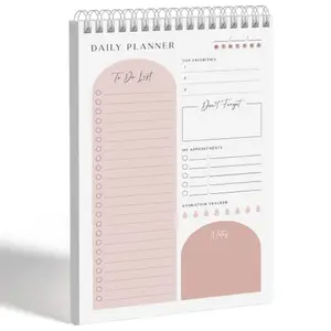 Coral-colored Makaplan daily planning notepad with twin-ring binding and protective cover