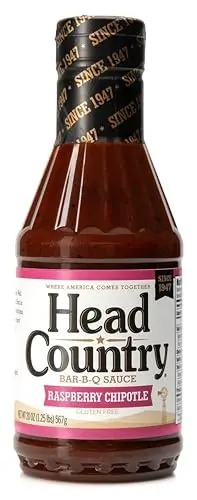 Head Country Raspberry Chipotle BBQ Sauce 20oz bottle with grilled meats
