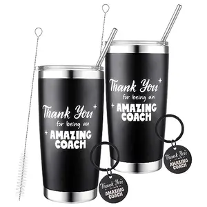 Two stainless steel coach tumblers with matching keychains and straw brushes
