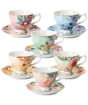 Set of six vintage floral tea cups with pastel patterns and gold trim on a white background