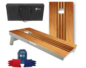 Tailgating Pros all-weather cornhole boards with retro wood design, standing on a patio