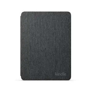 Official Amazon Kindle Paperwhite case in black fabric, lying flat on a wooden table next to a Kindle