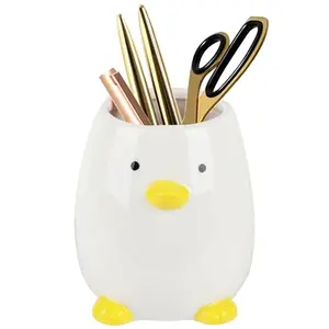Cute white owl ceramic pencil cup on a desk