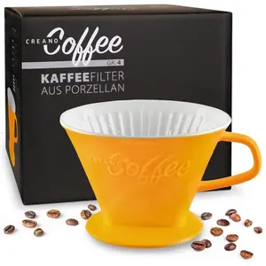 Creano Porcelain Coffee Dripper in saffron yellow, sitting on a cup