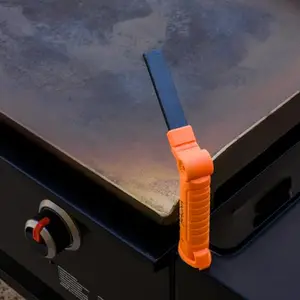 Magna Outdoors light attached to a griddle side shelf shining on the cooking surface
