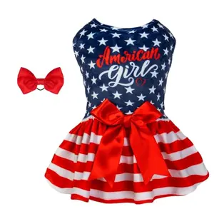 Small dog wearing a soft velvet American-themed CuteBone onesie dress with a matching red bow hair rope