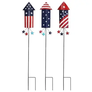 Three tall metal firework pattern garden stakes in red, white, and blue