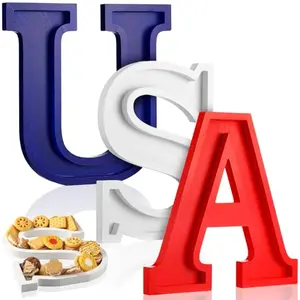 Wooden USA letter trays filled with snacks on a picnic table