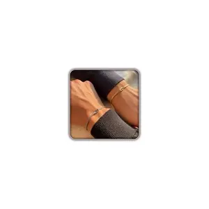 Gold and silver love knot chain couple bracelets on a wrist
