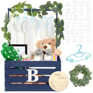 Navy blue wooden crate with baby hangers, garland, and letters